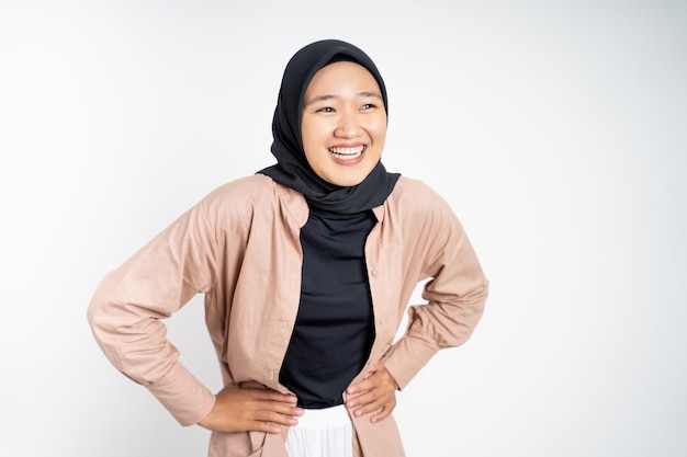 Happy asian muslim woman stand with hands on hip