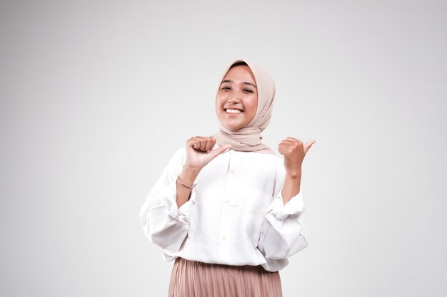 Happy asian muslimah posing in front of camera isolated white background