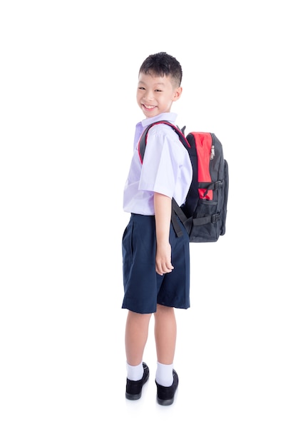 Happy asian schoolboy standing over white background