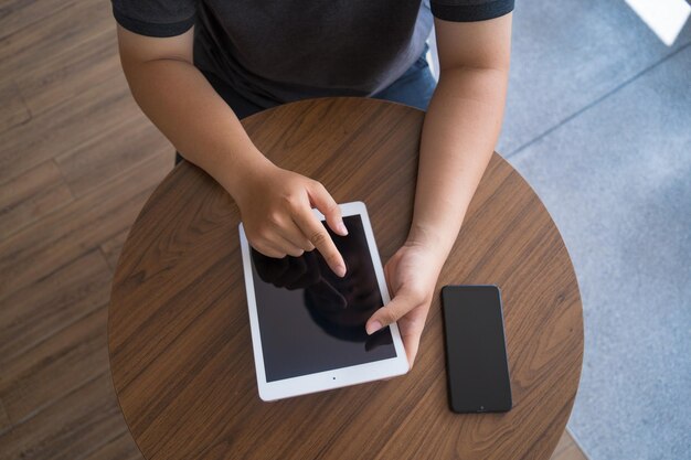 Happy Asian teenager using smart phone and tablet at coffee shop Asian man holding tablet call mom