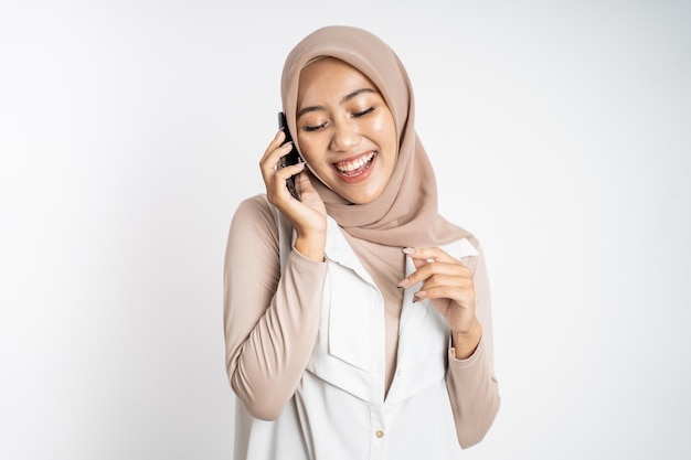 Happy asian woman making a call using a cell phone