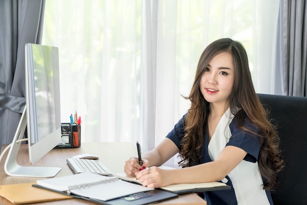 happy asian woman in office 