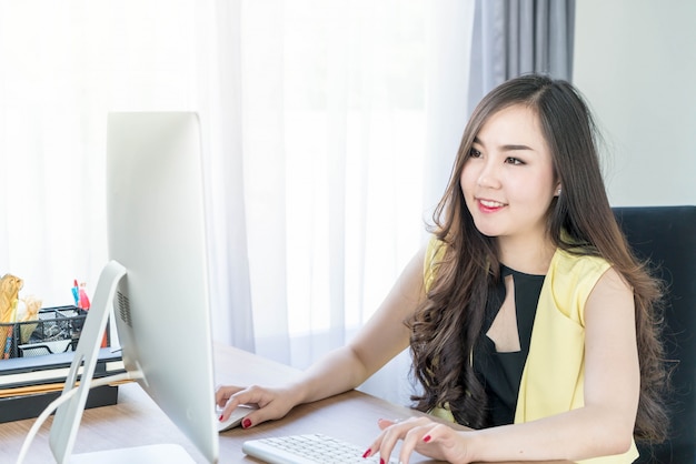 happy asian woman in office 