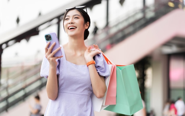 Happy asian woman shopping at mall