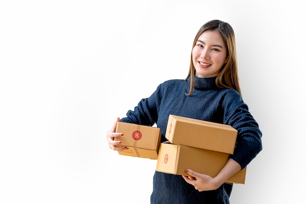 Happy Asian woman smiling and holding package parcel box isolated on white background