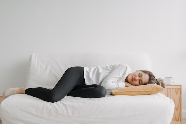 Happy asian woman taking a nap on the sofa on free empty day