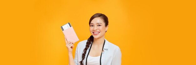 Happy Asian woman tourist holding passport