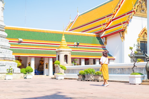 Happy Asian Woman Travel at temple in Thailand