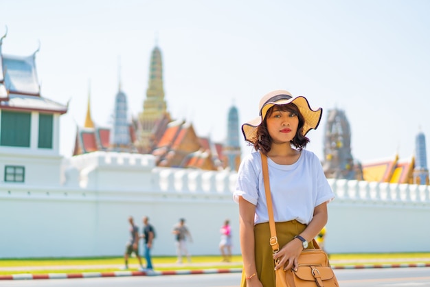 Happy asian woman visiting temple