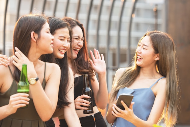 Happy asian women party with beer in nightclub.