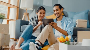 Premium Photo | Happy asian young couple man and woman use tablet ...