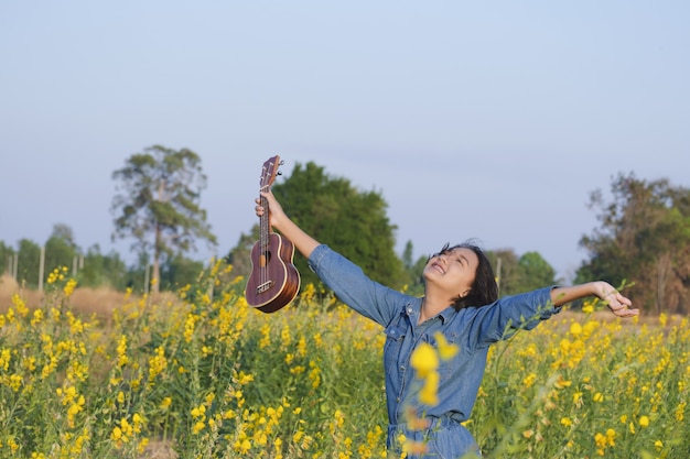 Happy Asian young girl at flower garden on summer with nice sky.