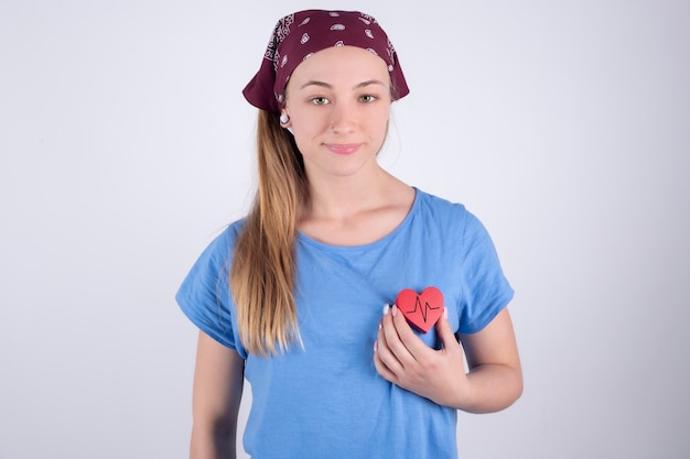 Photo happy athlete holding a healthy red heart rate. the strength of the medical heart empowering lifestyle. female. cardiac health and wellness.