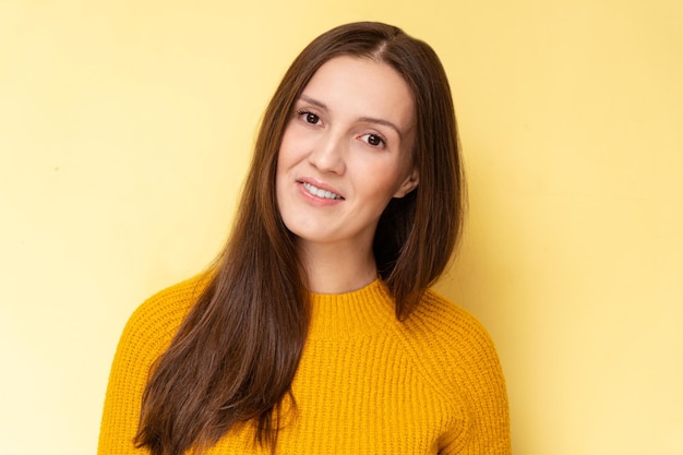 Happy attractive tatar young woman smiling and laughing isolated on yellow background with copy space face portrait