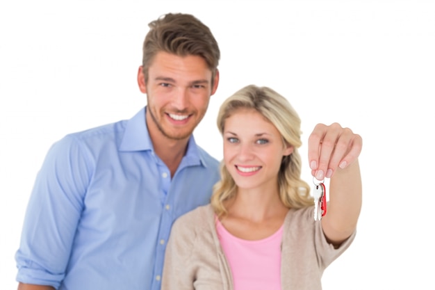 Happy attractive young couple holding new house key