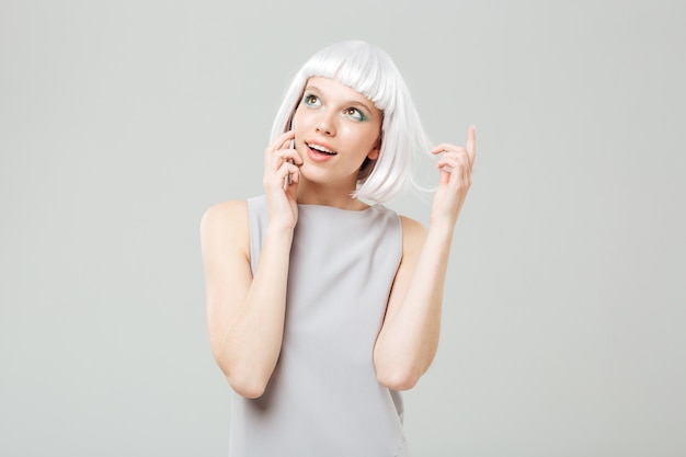 Happy attractive young woman talking on cell phone