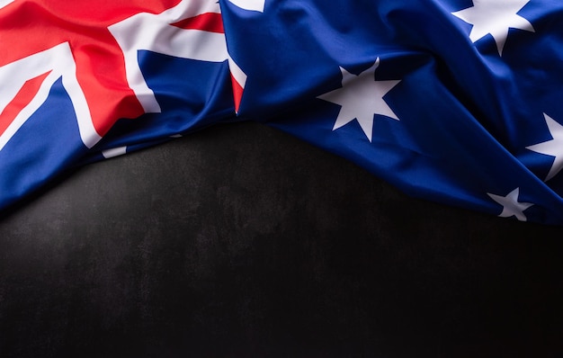 Happy Australia day concept Australian flag against dark stone background 26 January