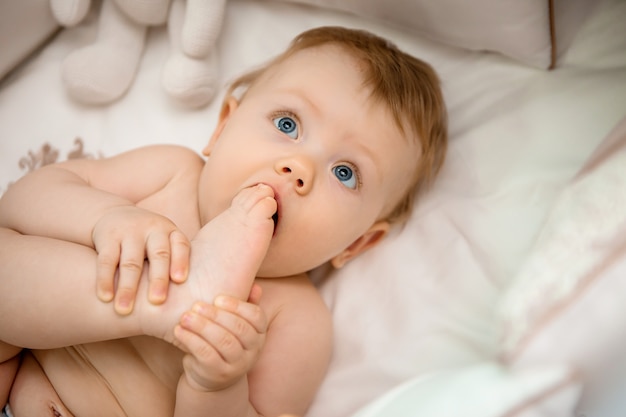 happy baby on a bed at home