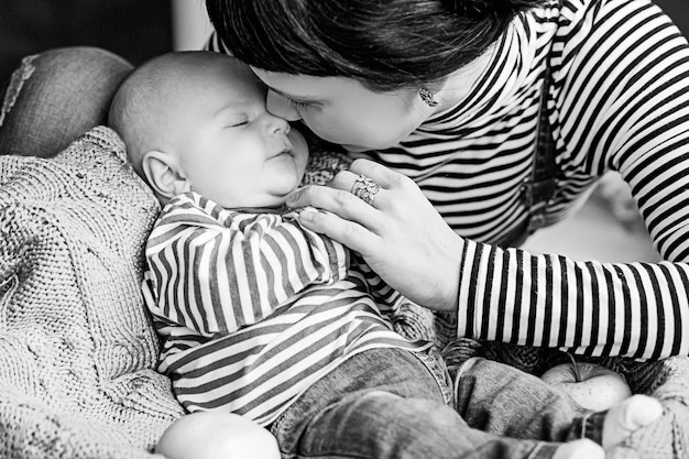 Happy baby boy with his mother face to face