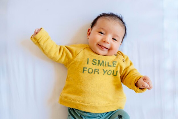 Happy baby girl smiling on the bed