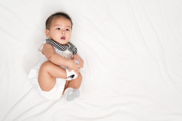 Happy baby newborn on a bed