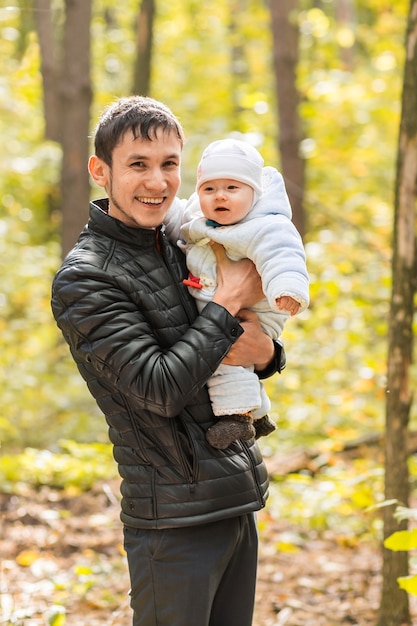 Happy baby with his father outdoors in spring