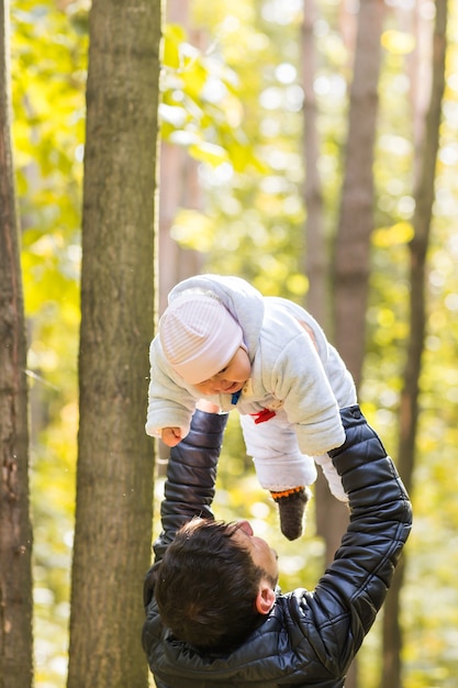 Happy baby with his father outdoors in spring