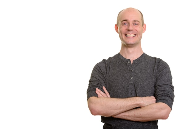 Happy bald Caucasian man smiling with arms crossed