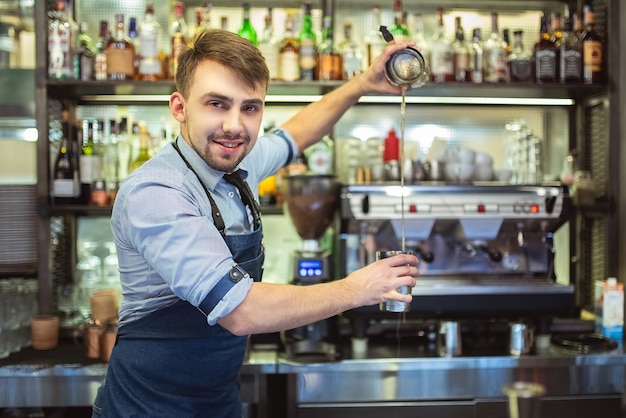 The happy bartender working on the bar