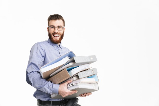 Happy bearded elegant man in eyeglasses holding folders and looking