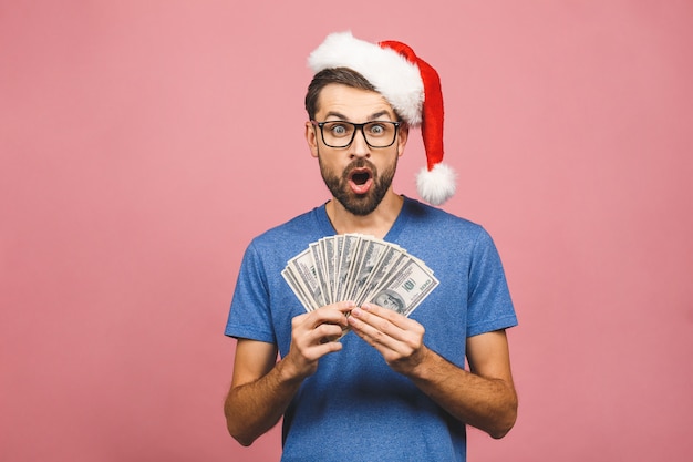 Happy Bearded man in casual and christmas hat holding money