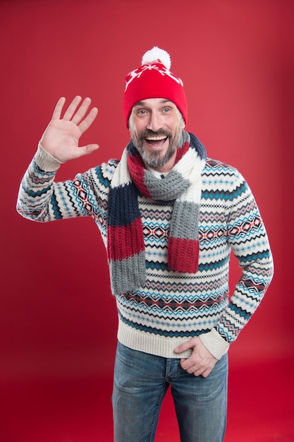 Happy bearded man welcomes you. Cold winter conditions. Knitted accessories. Winter weather style. Winter male fashion collection. Mature man enjoy warmth and comfort. Christmas holiday time.