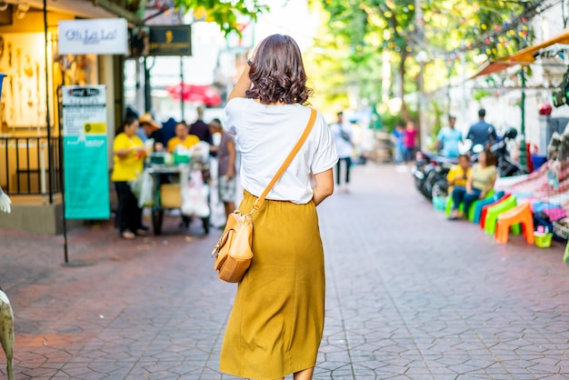 Happy and Beautiful Asian woman traveling at Khao Sarn Road, Thailand