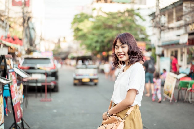 Happy and Beautiful Asian woman traveling at Khao Sarn Road, Thailand