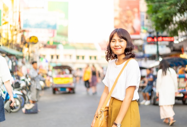 Счастливая и красивая азиатская женщина путешествуя на Khao Sarn Road, Таиланде