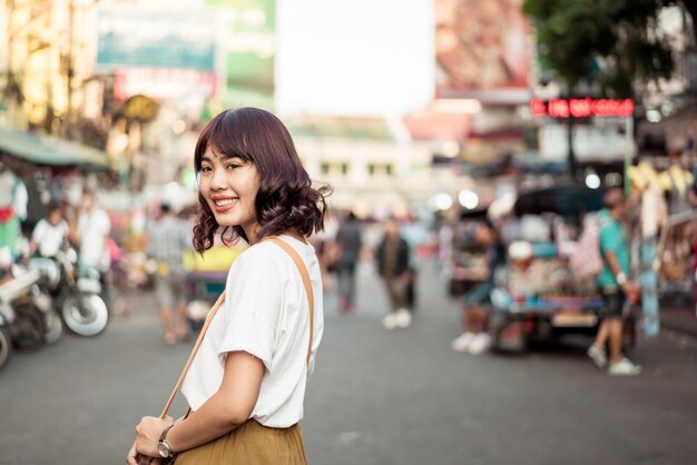 Happy and Beautiful Asian woman traveling at Khao Sarn Road, Thailand