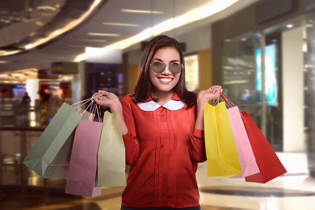 Happy beautiful asian woman with shopping bags