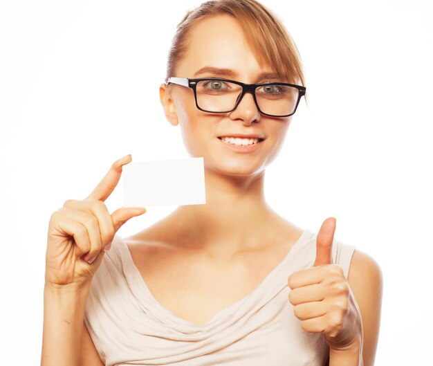 Happy beautiful businesswoman wearing glasses holding a blank card