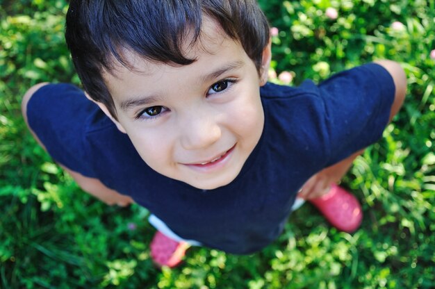 Happy beautiful child on ground outdoor