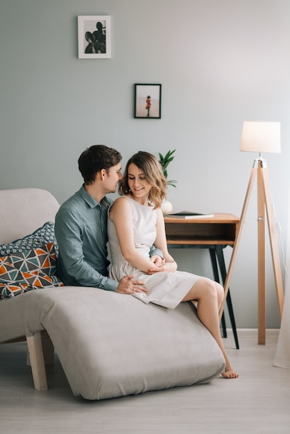 Happy beautiful couple is spending the weekend together at home, relaxing