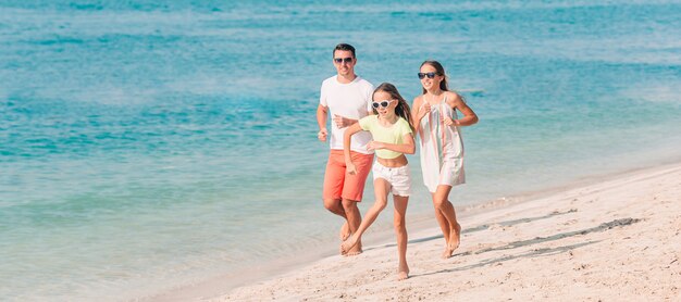 Happy beautiful family on a tropical beach vacation