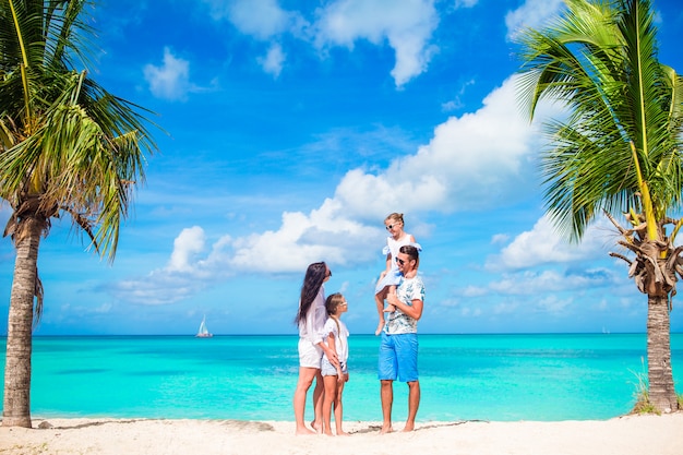 Happy beautiful family on white beach having fun