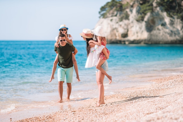 Happy beautiful family with kids on the beach