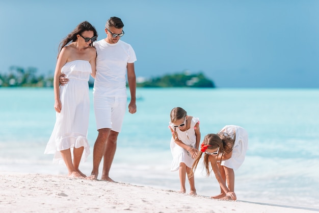 Happy beautiful family with kids on the beach