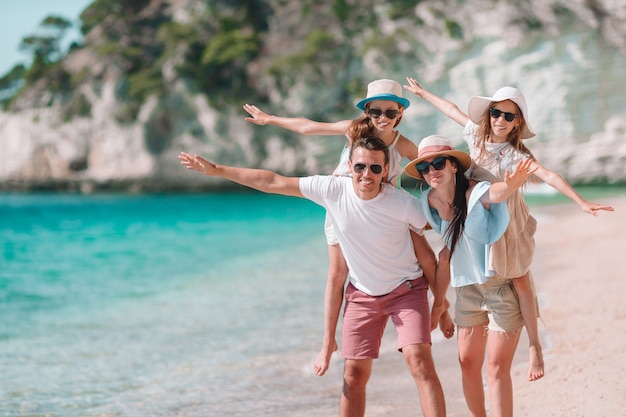 Happy beautiful family with kids on the beach