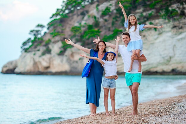 Happy beautiful family with kids on the beach