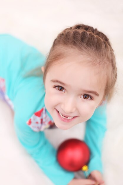 Happy beautiful girl celebrating New Year at home