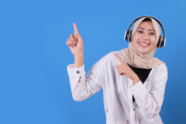 Happy beautiful girl enjoying listening music in wireless headphones