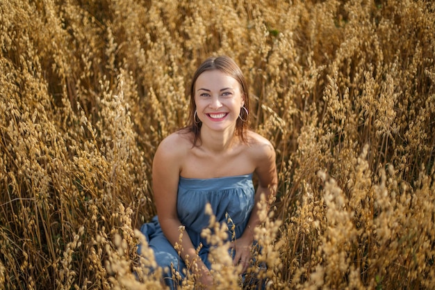 Happy and beautiful girl in a wheat field in Ukraine