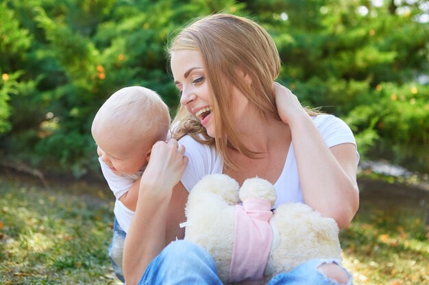 Happy beautiful mother and baby daughter or son